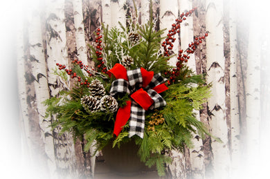 Example of a decorated evergreen planter. Bow and decorations are an extra fee based on what is added.